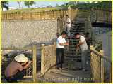 workmen weaving the hemp rope webbing along an elevated area of the Xiamen boardwalk